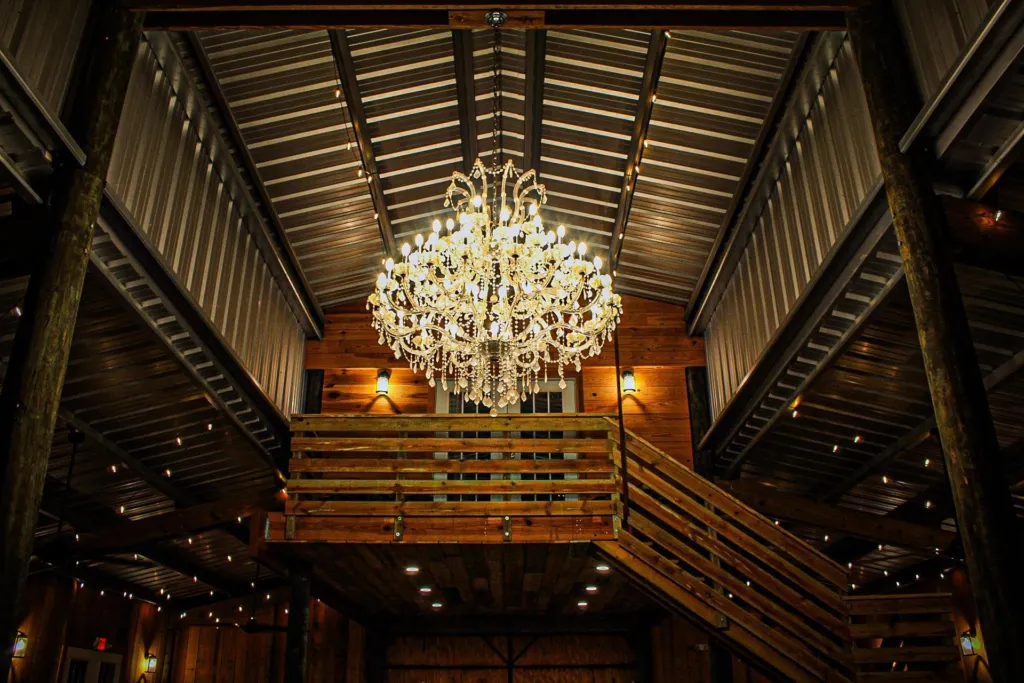 The barn's antique crystal chandelier lit in front of the loft