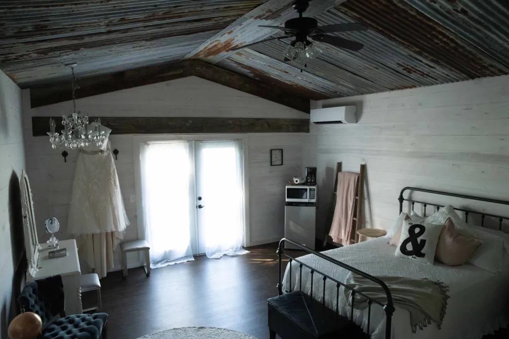 The bridal suite with a vanity, iron bed and French doors