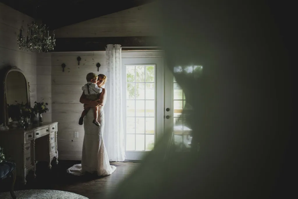 Bride standing by the bridal suite window
