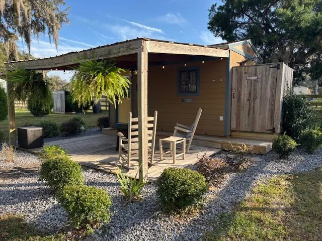 Cowboy Cabin with its covered porch and landscaped yard