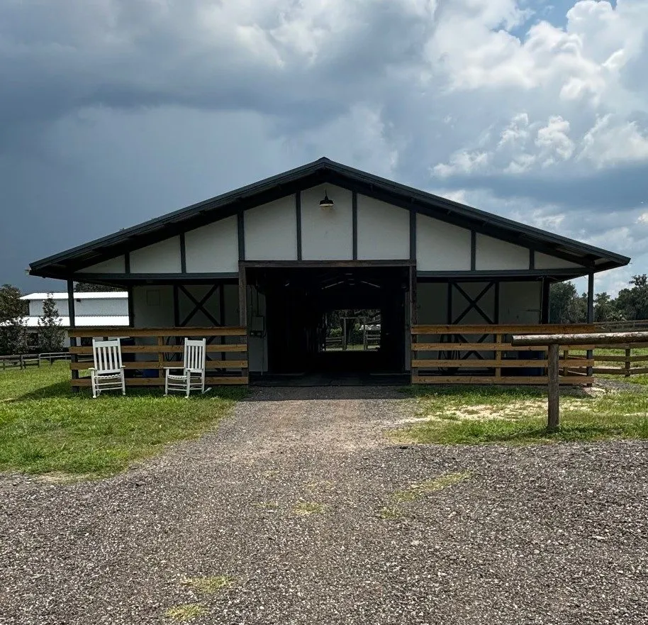 Horse barn under a stormy sky